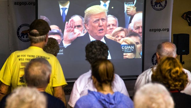 Donald Trump supporters pack the Arizona Republican Party office in Sun City as they watch the inauguration of the 45th president of the United States via a live television feed on Jan. 20, 2017.