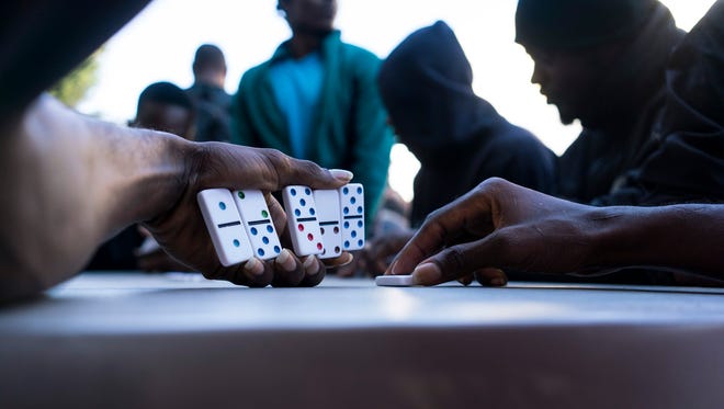 Haitian migrants play dominos in October in Tijuana, Mexico at Desayunador Salesiano Padre Chava, a shelter where immigrants get free breakfast and some other necessities. Most of these Haitians coming from Brazil are trying to enter the United States.