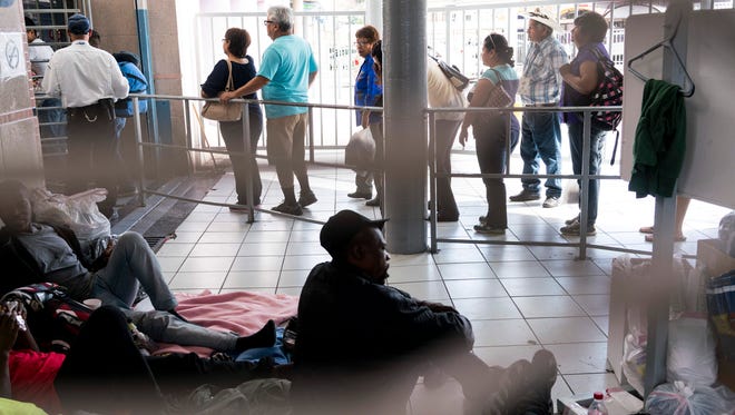 Haitian migrants line the floor of the DeConcini port of entry in Nogales, Sonora,  in October, hoping to speak with U.S. Customs and Border Protection officers. Larger numbers of Haitians, coming from Brazil, have been arriving at ports in hopes of entering the U.S. on humanitarian parole. After a wave of migrants from Central America arrived, U.S. Immigration and Customs Enforcement officials have released 900 Haitian nationals due to a lack of detention space.
