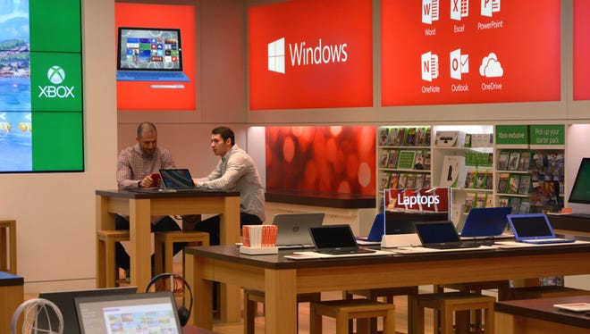 Microsoft employees prepare for the grand opening of the Chandler Fashion Center store on Nov. 14, 2014.