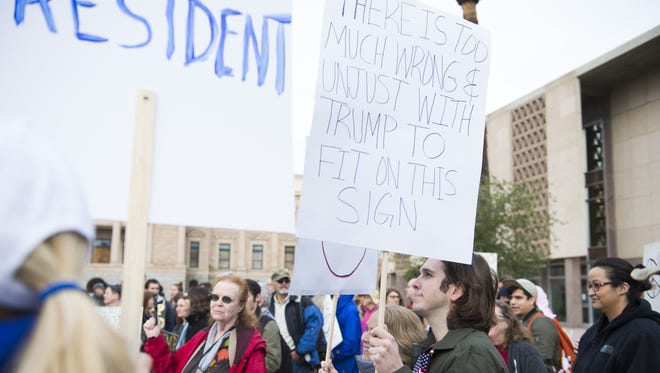 Demonstrators protest against the inauguration of Donald Trump as the 45th president of the United States at the Arizona state Capitol in Phoenix on Jan. 20, 2017. Trump's election to the presidency has sparked protests since Election Day.