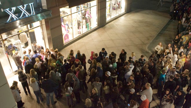 Long lines of young shoppers waited outside XXI at Chandler Fashion Center on Black Friday in 2014.