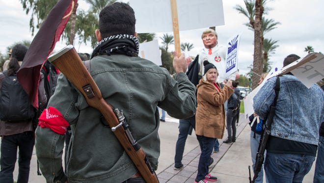 Some pro-Trump demonstrators carried guns during protests at the Arizona state Capitol on inauguration day. Several hundred people protested the inauguration of Donald Trump as the 45th president of the United States on Jan. 20, 2017, in Phoenix.