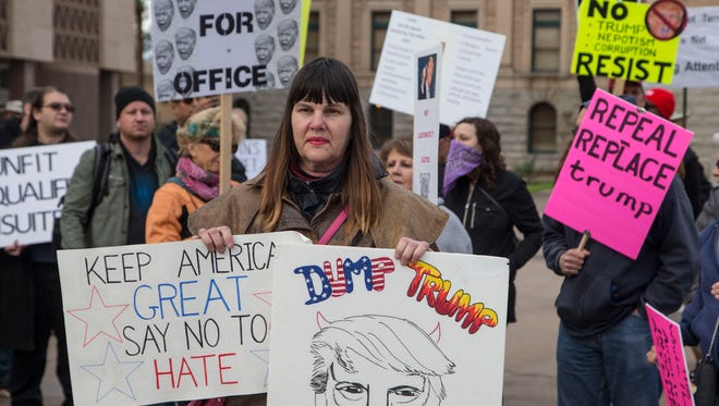Several hundred people protest at the Arizona state Capitol during the inauguration of Donald Trump as president of the United States on Jan. 20, 2017.