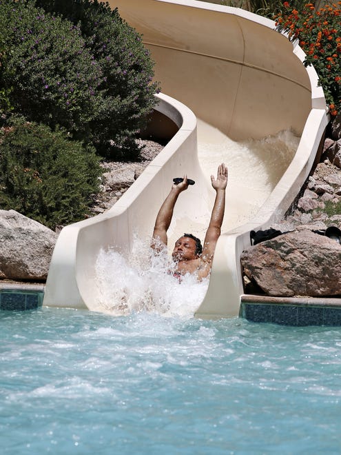 A guest swooshes into the Sonoran Splash pool at the Fairmont Scottsdale Princess resort.