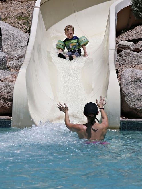 A mom waits for her son at the foot of the slide in the Sonoran Splash pool at the Fairmont Scottsdale Princess.