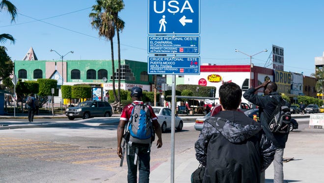 Haitian migrants walk towards the San Ysidro Port of Entry in Tijuana, Mexico, in October.  They were scheduled to be interviewed by U.S. Customs and Border Protection officers in hopes of entering the U.S. even though they didn't have visas.
