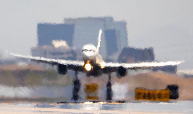Heat shimmer causes visual distortion as Delta Airlines flight DL796 from Atlanta touches down at Phoenix Sky Harbor International Airport, as the city experienced the 15th day in a row of temperatures at 110 degrees or more on July 14, 2023.