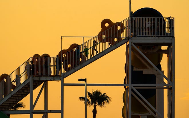 Rafts are carried up the stairs to ride Thunder Falls during sunset at Golfland Sunsplash on July 11, 2023, in Mesa.