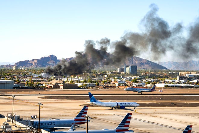 The Phoenix Fire Department battles a propane fire in 119-degree heat near Phoenix Sky Harbor International Airport on July 20, 2023.