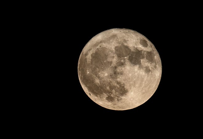 A full moon shines in the night sky in Surprise, Ariz., on Aug. 1, 2023.