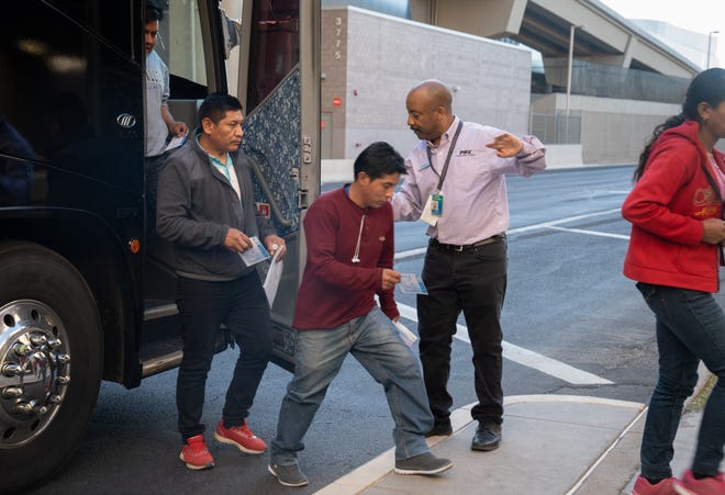 Migrants, released in Yuma, arrive by bus at Sky Harbor International Airport in Phoenix on Dec. 16, 2023.