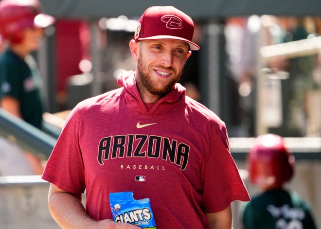 Arizona Diamondbacks pitcher Merrill Kelly (29) in the dugout against the Los Angeles Dodgers during a spring training game at Salt River Fields in Scottsdale on March 23, 2023.