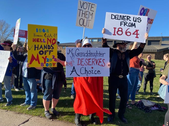 Just a few of the dozens of protesters demonstrating against the state's reinstated abortion ban outside Flagstaff City Hall on April 12, 2024.