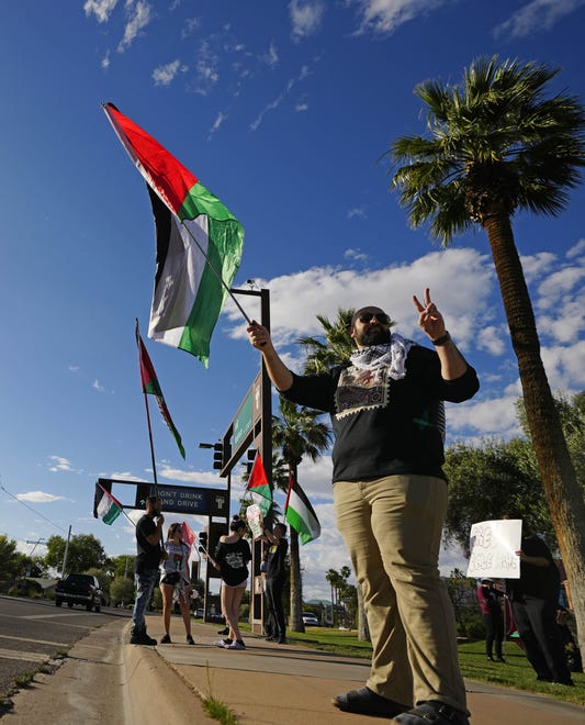 Protesters hold Palestinian flags at ASU Gammage on April 27, 2024, during a pro-Palestinian protest supporting a cease-fire in the Gaza Strip.