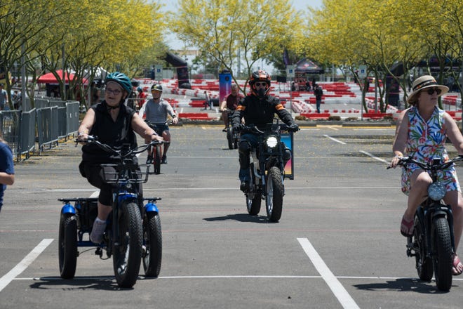 Attendees take test rides of various electric bikes on a course at the Electrify Expo outside State Farm Stadium on May 4, 2024 in Glendale, Ariz.