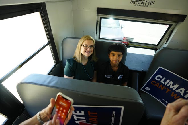 Mayor Kate Gallego and Ernesto Gomez, Isaac Middle School student, sit in the back of the new electric bus during a news conference and ride-along for the new electric school bus in Phoenix on May 7, 2024.