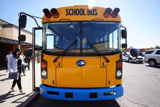 Guests load onto the new electric bus at Isaac Middle School during a news conference and ride-along for the new electric school bus in Phoenix on May 7, 2024.