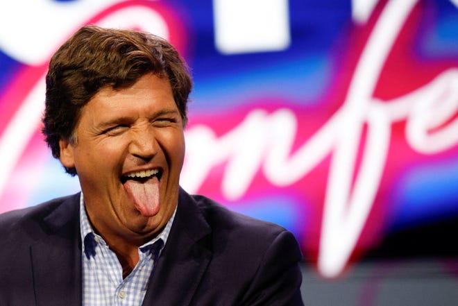 Former Fox News commentator Tucker Carlson reacts as he speaks during the Turning Point Action Conference in West Palm Beach, Fla., July 15, 2023.