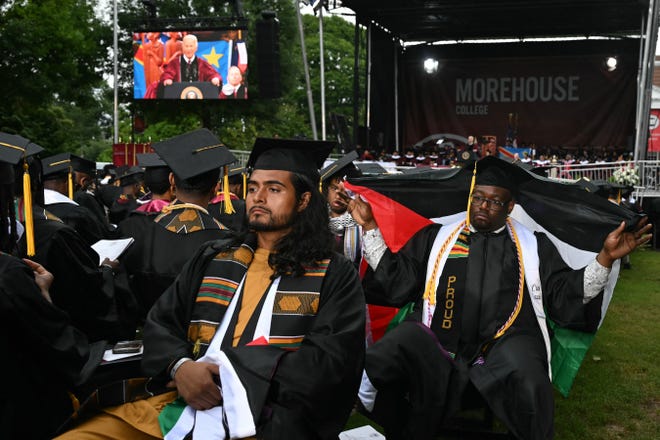 Graduating students turn their back on US President Joe Biden as he delivers a commencement address during Morehouse College's graduation ceremony in Atlanta, Georgia on May 19, 2024. Biden's graduation speech at Morehouse College, the university attended by the late rights icon Martin Luther King, Jr, will be his most direct engagement with students since demonstrations over Israel's war in Gaza roiled campuses across the United States.