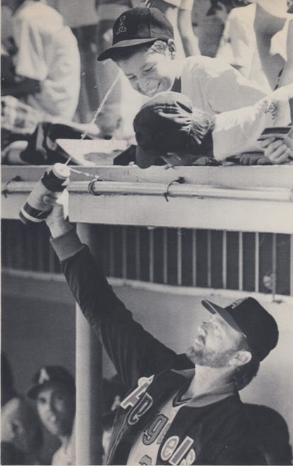 An Oakland A’s player squirts a child in the stands during spring training on March 3, 1989.
