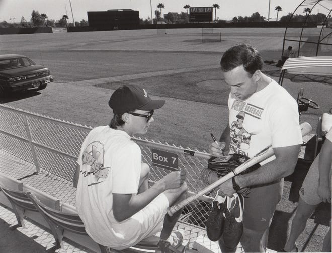 Kerry Reeder, of Tempe, has a baseball card signed by Seattle Mariners catcher Dave Vaile after the lockout was over during spring training March 19, 1990.