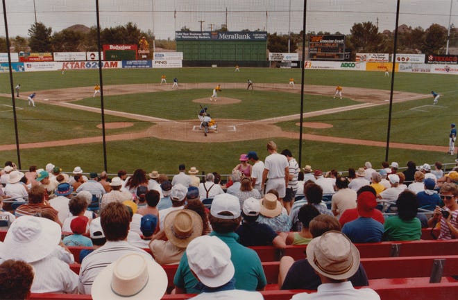 Fans watch a game between the Chicago Cubs and the Oakland A’s at Phoenix Municipal Stadium during the first day of Cactus League play during spring training on March 27, 1990.