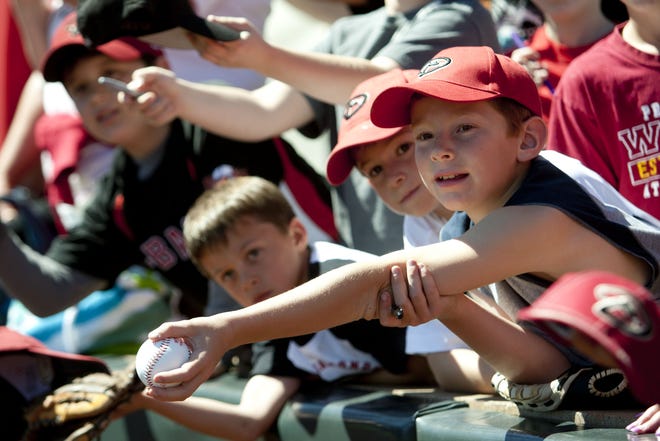 Diamondbacks fan Johnathan Rohrer, 8, of Phoenix, waits for autographs before the Cactus League spring-training game between the Diamondbacks and the Brewers at Salt River Fields at Talking Stick on the Salt River Reservation on March 21, 2012.