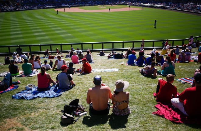 Baseball fans watch the game from the lawn as the Arizona Diamondbacks face off against the Colorado Rockies during spring training on March 27, 2016, at Salt River Fields at Talking Stick on the Salt River Pima Maricopa Indian Community.