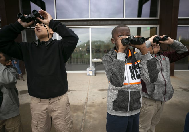 Angel Diaz (left), 10, Gumar Kueth (back right),12, and Andre Anderson, 9, all from the Tri-City West Thornwood Branch of Avondale of the Boys & Girls Clubs of Metro Phoenix, bird-watch at the Nina Mason Pulliam Rio Salado Audubon Center in Phoenix on Dec. 6, 2018.