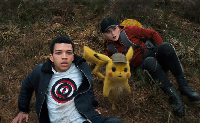 Tim (Justice Smith) and Pikachu (voiced by Ryan Reynolds) partner with Lucy (Kathryn Newton) and her Psyduck to solve the case in "Pokemon Detective Pikachu."