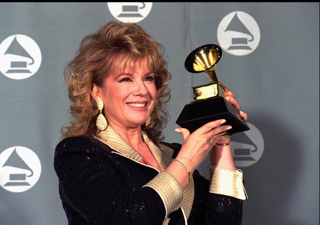 Vikki Carr holds up the Grammy she received for Best Mexican-American Performance for "Recuerdo A Javier Solis" at the 37th annual Grammy Awards on March 1, 1995, in Los Angeles.