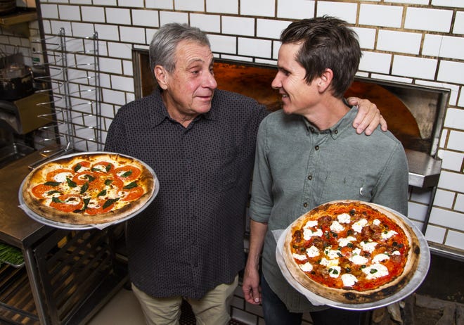 Danny Mei (left), owner of Nello's of Ahwatukee, and his son, Aric Mei, owner of The Parlor, show off some of the delicious pizzas offered at The Parlor on Nov. 14, 2019.