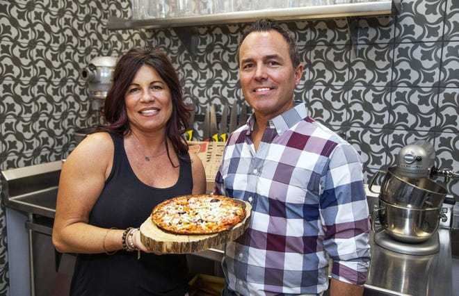 Nicole Spinato-Kienlen and her husband, Chris Kienlen, help to carry on the family tradition of Spinato's Pizzeria. They pose at the corporate offices in Tempe on Nov. 14, 2019.