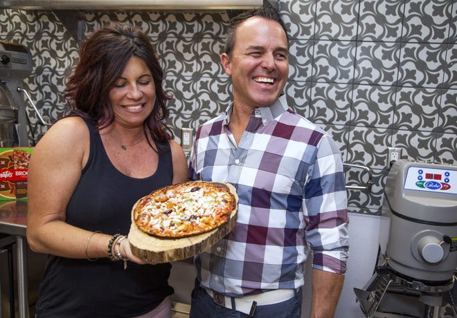 Nicole Spinato-Kienlen and her husband, Chris Kienlen, help to carry on the family tradition of Spinato's Pizzeria. They pose at the corporate offices in Tempe on Nov. 14, 2019.