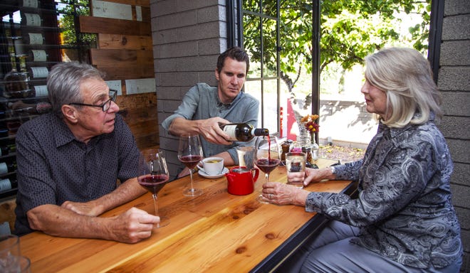 Danny Mei (left), owner of Nello's of Ahwatukee; and his son, Aric Mei (middle), owner of The Parlor; and  Danny's wife and Aric's mother Barbara Mei enjoy some wine at The Parlor on Nov. 14, 2019.