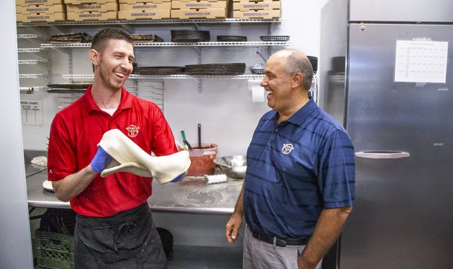 General manager Justin Fasching spins pizza dough while talking with Mike Barro at the Barro's Pizza in Glendale, on Nov. 15, 2019. Barro is carrying on the family tradition of owning pizza restaurants.