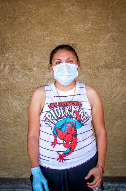 Paulina Ramirez stands for a portrait outside Safeway in Phoenix on April 5, 2020.