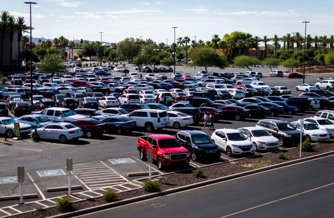 Dozens of cars fill the parking lot at Chander Fashion Center on May 23, 2023, after Arizona ' s stay-at-home order was lifted.
