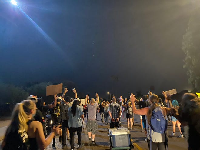 Protesters walk along Encanto Boulevard in Maryvale on July 5, 2020, during a protest for a man Phoenix police shot and killed on the Fourth of July.