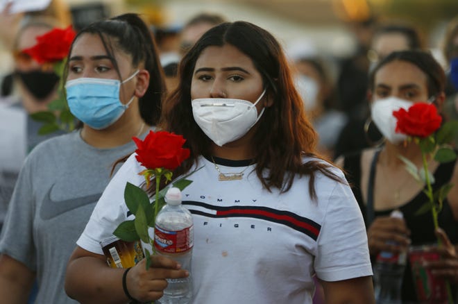 Protesters march down Glenrosa Avenue to the Garcia house during a Justice for James Garcia Rally in Phoenix on July 6, 2020.