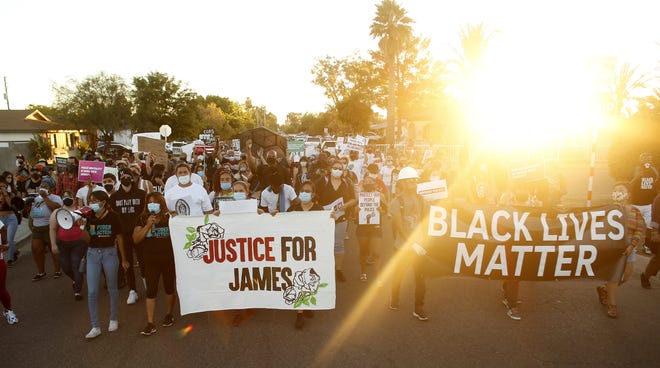 Protesters march down Glenrosa Avenue to the Garcia house during a Justice for James Garcia Rally in Phoenix on July 6, 2020.