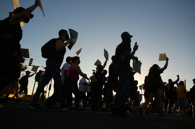 Protesters march down 59th Avenue during a Justice for James Garcia Rally in Phoenix on July 6, 2020.