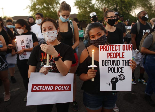 Protesters light candles during a Justice for James Garcia Rally in Phoenix on July 6, 2020. The protesters were demanding the releasing of all officer body-cam footage.