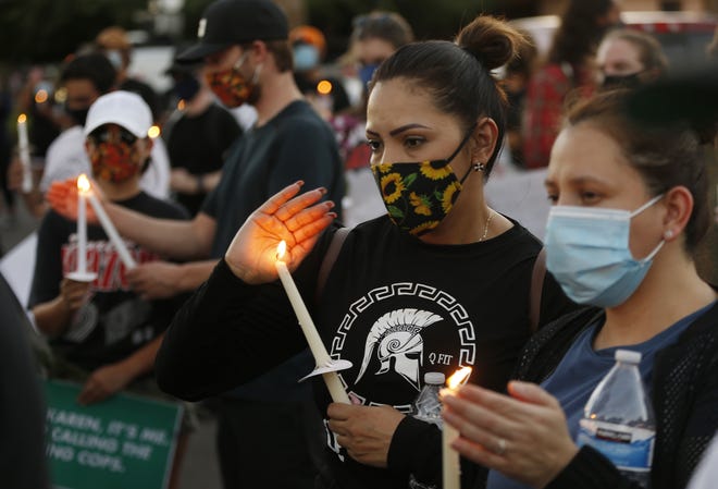 Candles are lit during a Justice for James Garcia Rally in Phoenix on July 6, 2020.