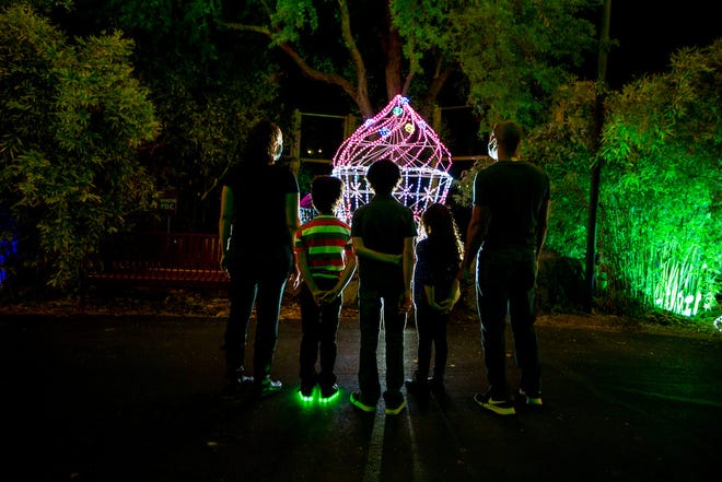 Phoenix Zoo’s annual Zoolights offers colorful light displays for people of different ages.