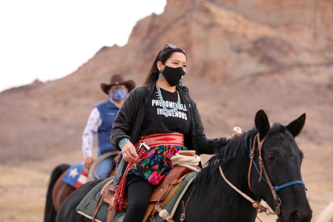 Diné Advocate Allie Young rides to the polls on horseback near Agathla Peak, which is north of Kayenta, Arizona, on Election Day. Young started the Ride to the Polls Initiative in an effort to encourage more Navajo voters to get out and vote.