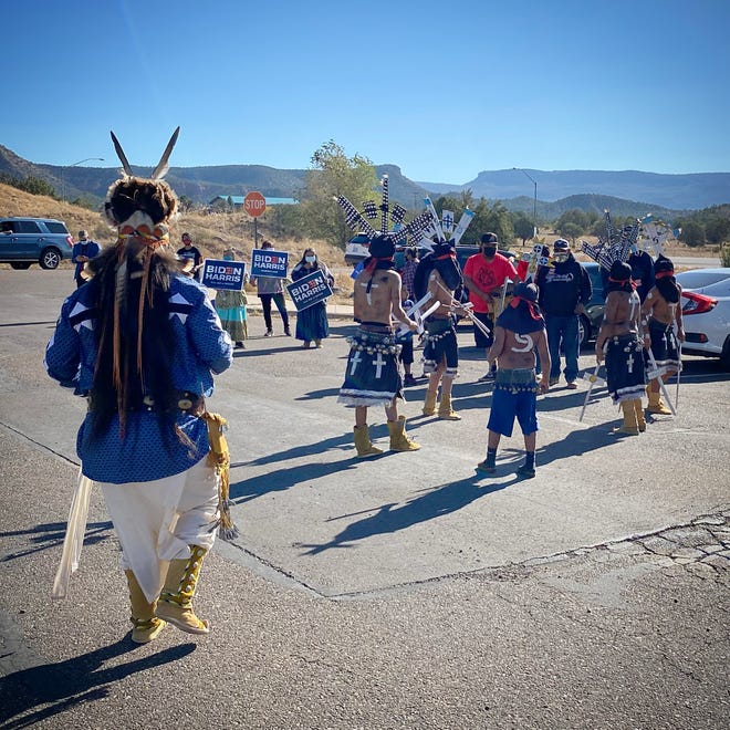 Voters from the White Mountain Apache Tribe are escorted to the polls in Whiteriver, Arizona, by a group of traditional Apache Crown Dancers on Election Day.