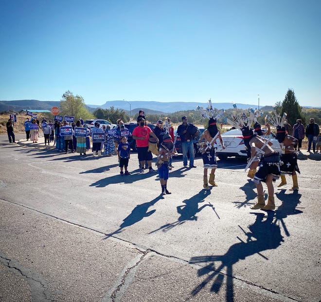 Voters from the White Mountain Apache Tribe are escorted to the polls in Whiteriver, Arizona, by a group of traditional Apache Crown Dancers on Election Day.