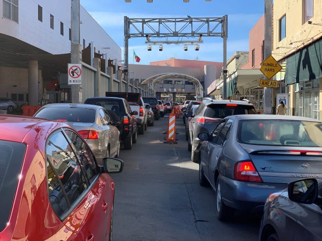 Líneas de automóviles con destino a México esperan la oportunidad de cruzar la frontera entre Estados Unidos y México en el puerto de entrada de DeConcini en las ciudades fronterizas de Nogales el 17 de diciembre de 2020